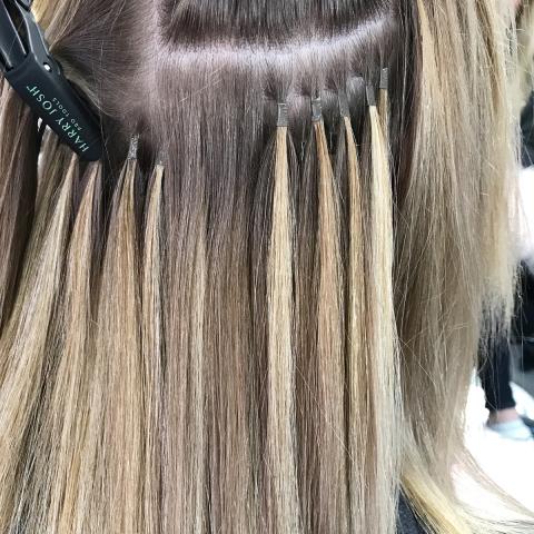 Micro Rings |A close up of blonde micro ring extensions added to the customer's hair.
